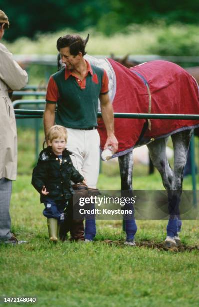 British Royals Charles, Prince of Wales, and his son, Prince Harry, attend a polo event at Cirencester Park Polo Club in Cirencester,...