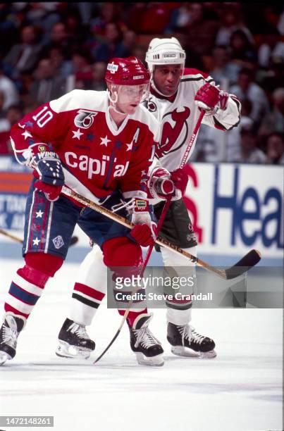 Washington Capitals forward, Kelly Miller, fights for position against Devil's Claude Vilgrain after a face off during the game against the NJ Devils...