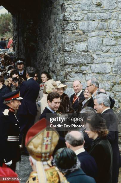 British Royal Charles, Prince of Wales, wearing a black suit with a blue-and-white striped shirt and a diagonally-striped tie, during a visit to St...