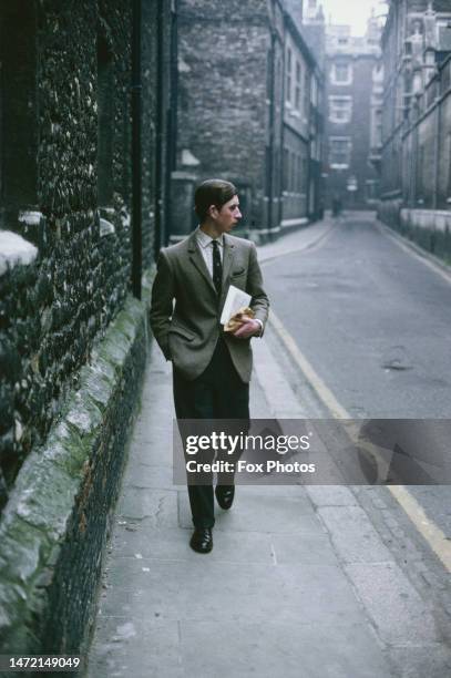 British Royal Charles, Prince of Wales, wearing a tweed jacket, a student at Trinity College, Cambridge University, walking in Cambridge,...