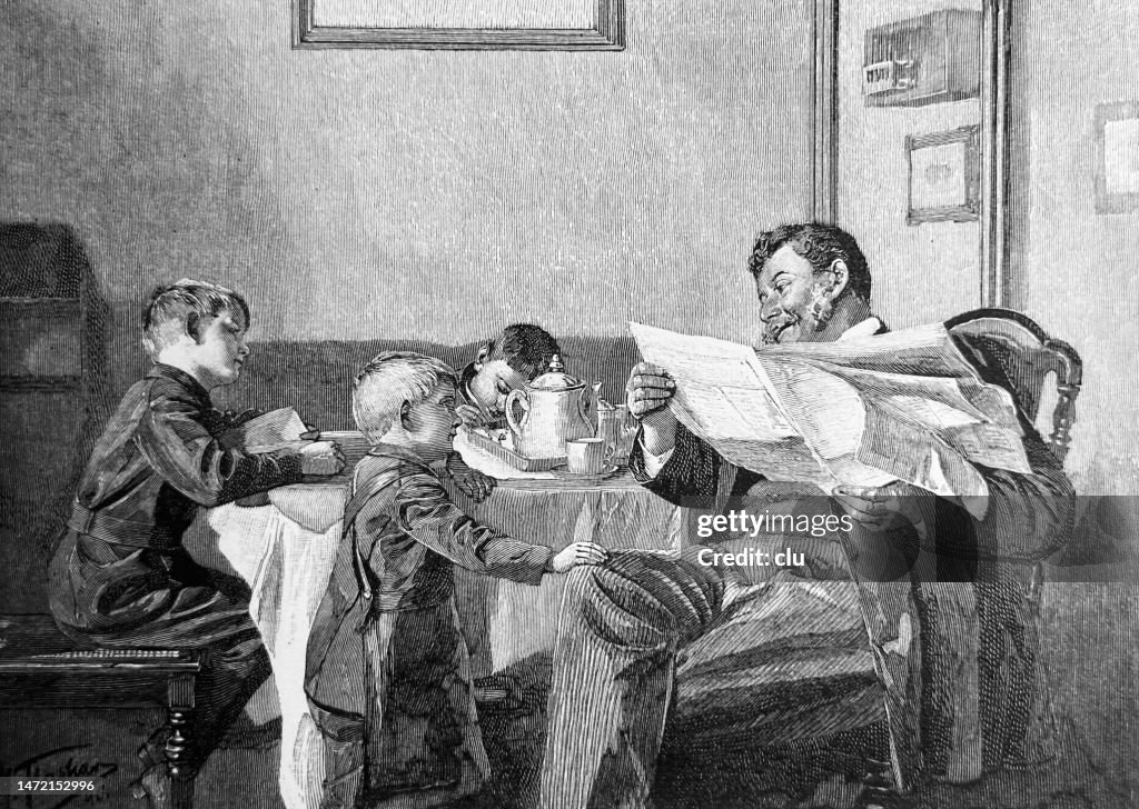 Father sits reading newspaper at the coffee table and explains the world to his 3 boys