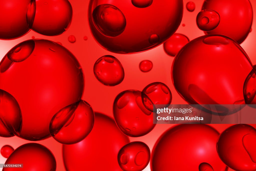 Red molecules, drops. 3D bubbles pattern. Beauty background. Cosmetic products for makeup and skin care. Blood cells. Medicine and healthcare.