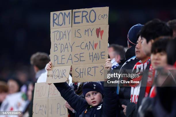 Fan of Tottenham Hotspur, holding a sign asking Cristian Romero of Tottenham Hotspur for their shirt, looks on prior to the UEFA Champions League...