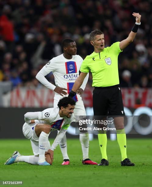 Marquinhos of Paris Saint-Germain goes down with an injury during the UEFA Champions League round of 16 leg two match between FC Bayern München and...