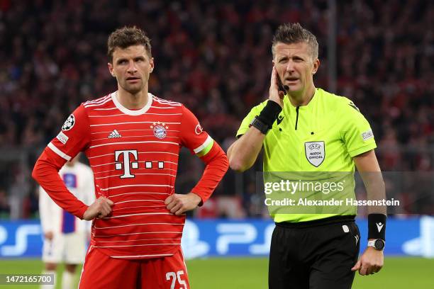 Referee Daniele Orsato reacts alongside Thomas Mueller of FC Bayern Munich before disallowing FC Bayern Munich first goal, scored by Eric Maxim...