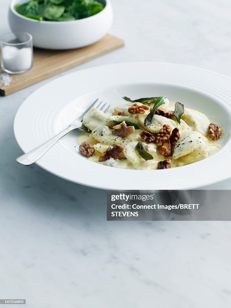 Plate of food topped with nuts