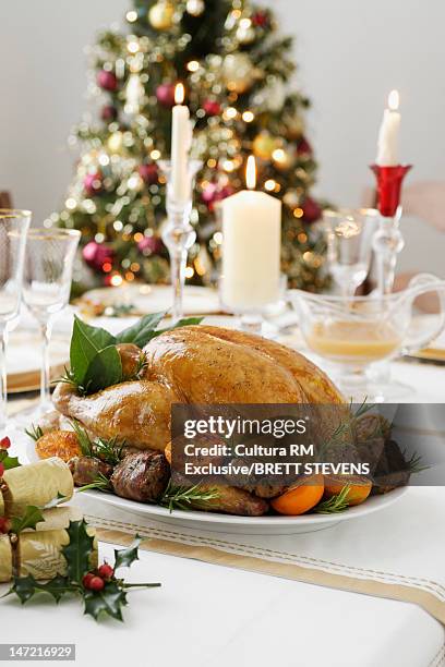 roast chicken on christmas dinner table - christmas table turkey stock pictures, royalty-free photos & images