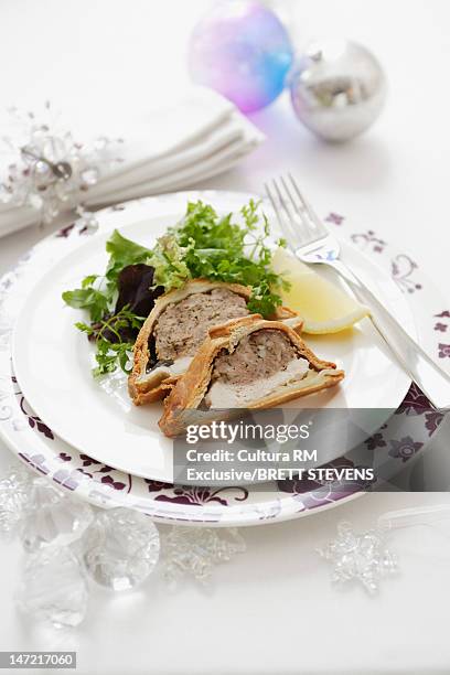 plate of baked meat pie with salad - pate stock-fotos und bilder