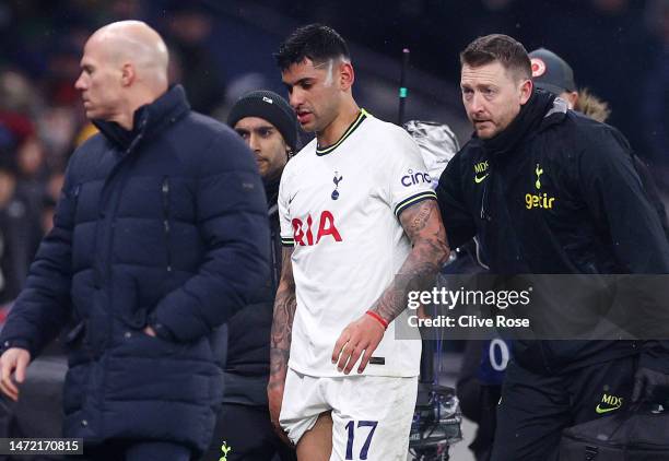 Cristian Romero of Tottenham Hotspur leaves the field with medical staff, after receiving a red card from Referee Clement Turpin during the UEFA...