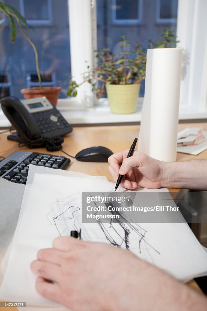 Architect sketching at desk
