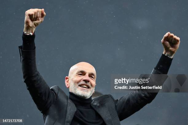 Stefano Pioli, Head Coach of AC Milan, celebrates victory in front of their fans after the UEFA Champions League round of 16 leg two match between...