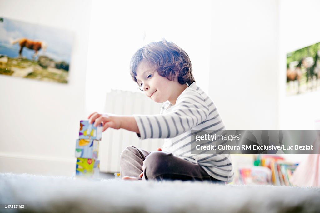 Boy playing with wooden blocks