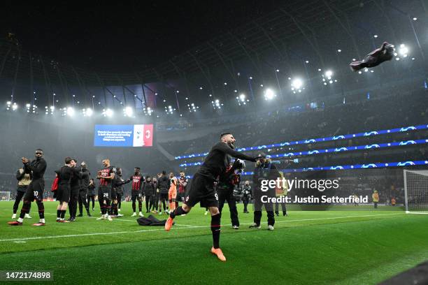 General view as Olivier Giroud of AC Milan throws their shirt into the crowd as they celebrate victory after the UEFA Champions League round of 16...