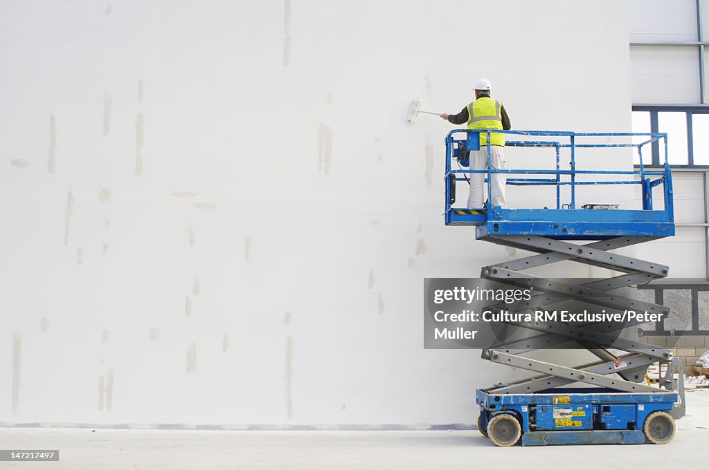 Workers painting on site