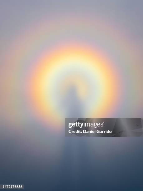 double rainbow halo around the shadow of a person and generated over the fog, gay pride backgrounds - aureool stockfoto's en -beelden