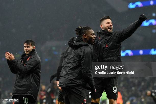 Olivier Giroud of AC Milan celebrates victory with teammate Rafael Leao after the UEFA Champions League round of 16 leg two match between Tottenham...