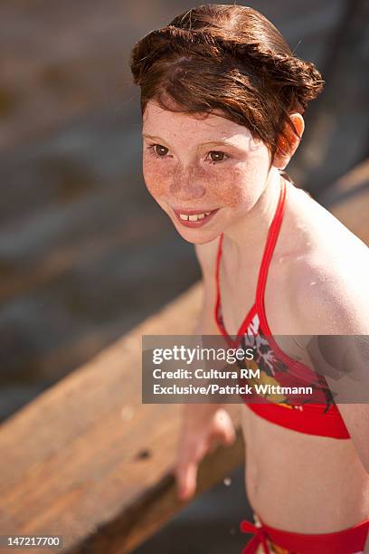 smiling girl wearing bikini outdoors - young girl swimsuit stock-fotos und bilder