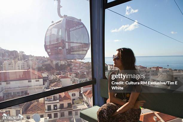 woman riding gondola over village - funchal stock pictures, royalty-free photos & images