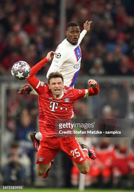 Thomas Mueller of Bayern Muenchen vies with Nuno Mendes of FC Paris Saint Germain during the UEFA Champions League round of 16 leg two match between...
