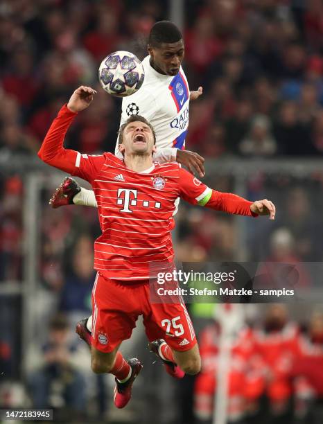 Thomas Mueller of Bayern Muenchen vies with Nuno Mendes of FC Paris Saint Germain during the UEFA Champions League Round of 16 Second Leg match...