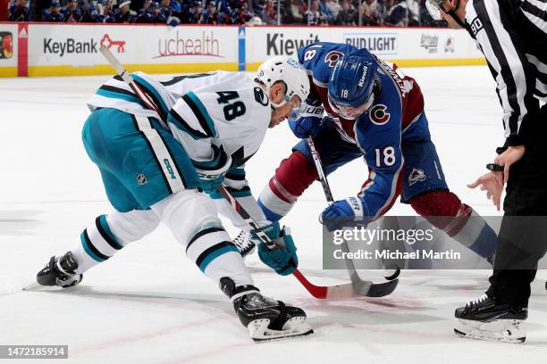 Alex Newhook of the Colorado Avalanche faces off against Tomas Hertl of the San Jose Sharks at Ball Arena on March 7, 2023 in Denver, Colorado.