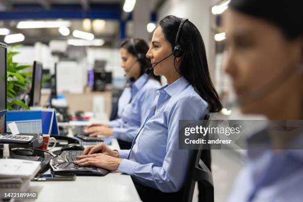 women working as customer service representatives at a call center - customer retention stock pictures, royalty-free photos & images