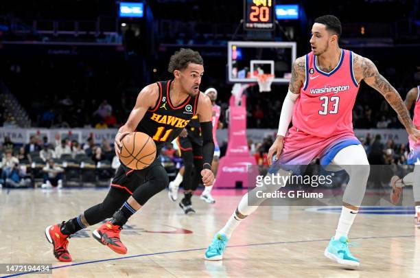 Trae Young of the Atlanta Hawks handles the ball in the first quarter against Kyle Kuzma of the Washington Wizards at Capital One Arena on March 08,...