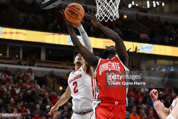 Jordan Davis of the Wisconsin Badgers blocks the shot of Isaac Likekele of the Ohio State Buckeyes in the second half during the first round of the...