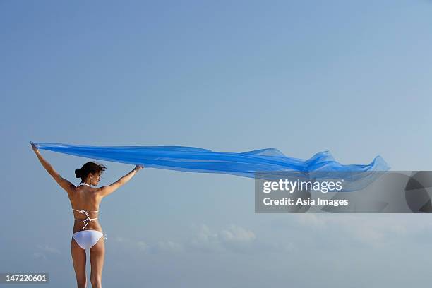 woman in bikini with flowing blue fabric - ショール ストックフォトと画像