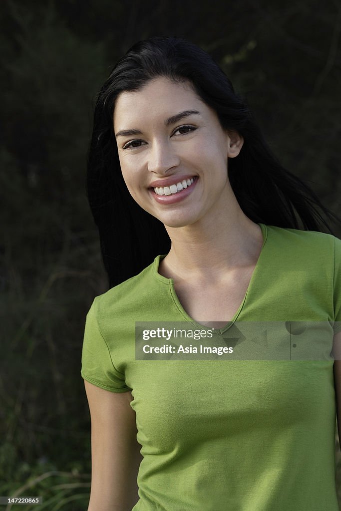 Portrait of woman wearing green shirt