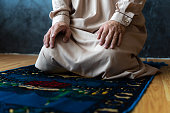 religious muslim man praying with rosary