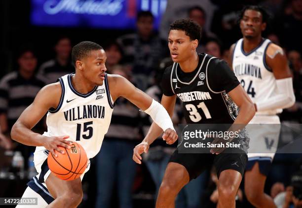 Jordan Longino of the Villanova Wildcats dribbles as Wayne Bristol Jr. #31 of the Georgetown Hoyas defends during the first half in the first round...