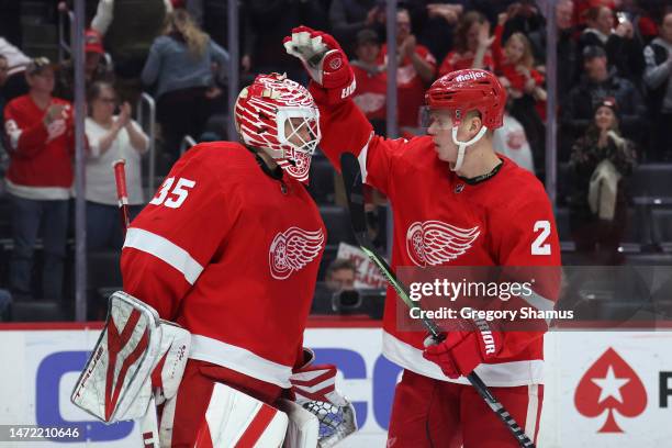 Ville Husso of the Detroit Red Wings celebrates a 4-3 win over the Chicago Blackhawks with Olli Maatta at Little Caesars Arena on March 08, 2023 in...