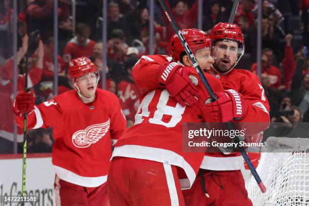 Dylan Larkin of the Detroit Red Wings celebrates his second period goal with Alex Chiasson and Lucas Raymond while playing the Chicago Blackhawks at...