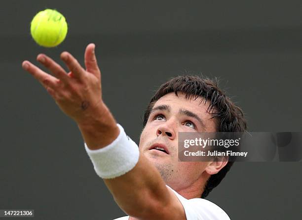 Jamie Baker of Great Britain serves the ball during his Gentlemen's Singles first round match against Andy Roddick of USA on day three of the...