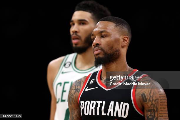 Damian Lillard of the Portland Trail Blazers looks on with Jayson Tatum of the Boston Celtics at TD Garden on March 08, 2023 in Boston,...
