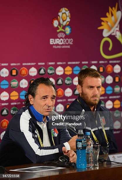 In this handout image provided by UEFA, Italy coach Cesare Prandelli speaks beside Daniele De Rossi during a press conference ahead of their UEFA...