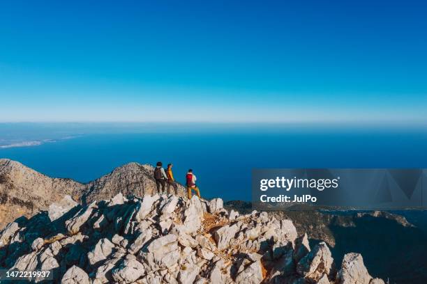 summiteers at the mountain peak, drone point of view - summit stock pictures, royalty-free photos & images