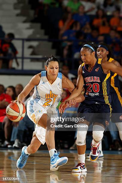 Ticha Penicheiro of the Chicago Sky pushes past Briann January of the Indiana Fever during the WNBA game on June 27, 2012 at the All-State Arena in...