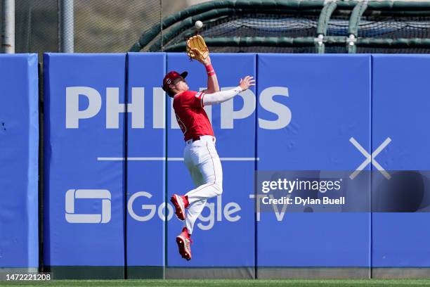 Mickey Moniak of the Los Angeles Angels leaps to catch a fly ball in the second inning against the Colorado Rockies during a Spring Training game at...