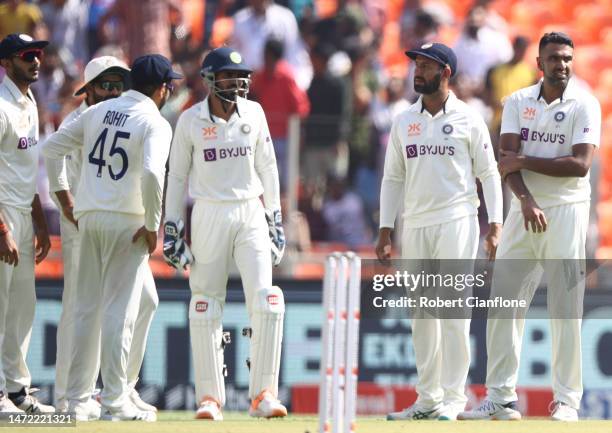 Ravichandran Ashwin of India celebrates taking the wicket of Travis Head of Australia during day one of the Fourth Test match in the series between...