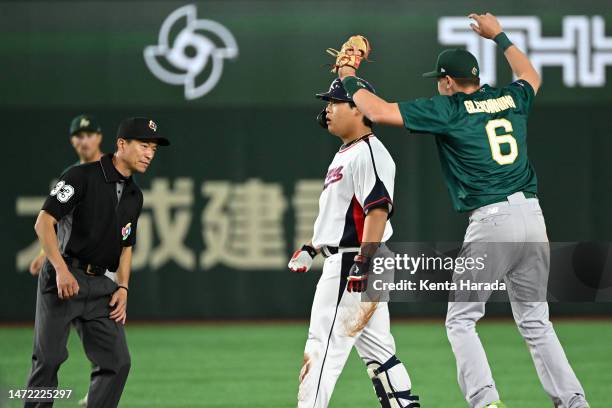 Baekho Kang of Korea is tagged out by Robbie Glendinning of Australia on the second hbase in the seventh inning during the World Baseball Classic...