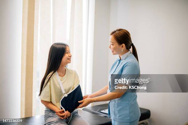 young girl with broken arm visits doctor - broken trust stock pictures, royalty-free photos & images