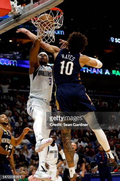 Jaden Hardy of the Dallas Mavericks dunks the ball over Jaxson Hayes of the New Orleans Pelicans during the fourth quarter of an NBA game at Smoothie...