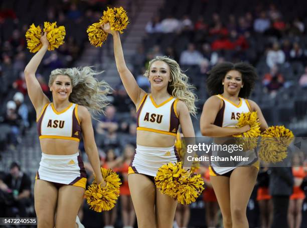 Arizona State Sun Devils cheerleaders run off the court after performing during a timeout in the team's first-round game of the Pac-12 basketball...