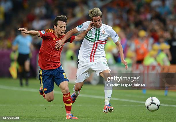 David Silva of Spain challenges Fabio Coentrao of Portugal during the UEFA EURO 2012 semi final match between Portugal and Spain at Donbass Arena on...