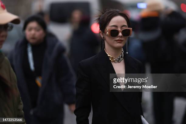 Fashion Week Guest seen wearing a black blazer, brown sunglasses, silver and golden necklace chain and grey handbag, outside Stella McCartney during...