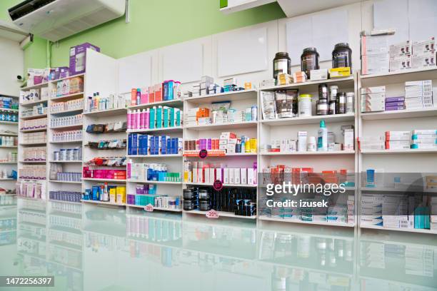 shelves with medicaments in pharmacy - pharmacy stockfoto's en -beelden