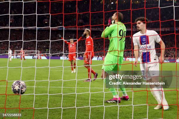 Vitinha and Gianluigi Donnarumma of Paris Saint-Germain look dejected as Eric Maxim Choupo-Moting of FC Bayern Munich celebrates after scoring the...