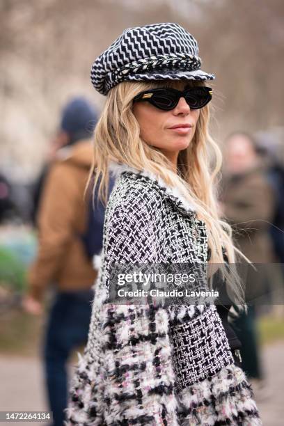 Erica Pelosini wears a black and white hat, black and white decorated jacket and black sunglasses, outside Chanel, during Paris Fashion Week -...